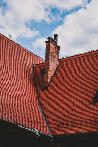tile roof orange roof view under blue and white skies yellow